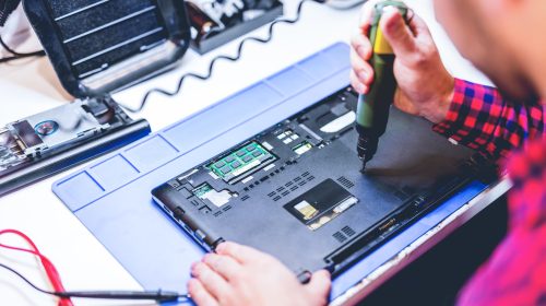 IT engineer technician repairing computer in electronics service shop