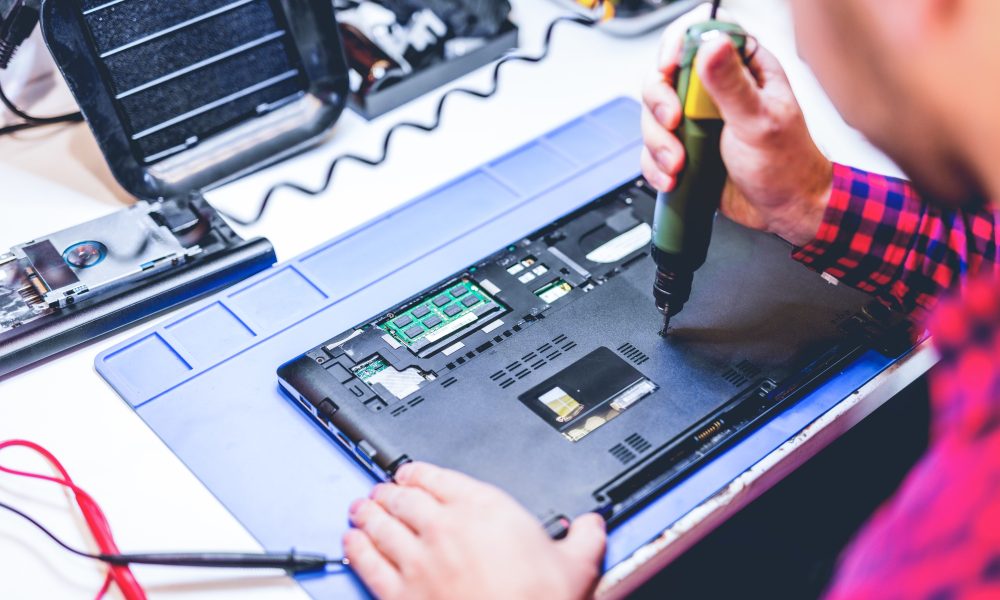 IT engineer technician repairing computer in electronics service shop