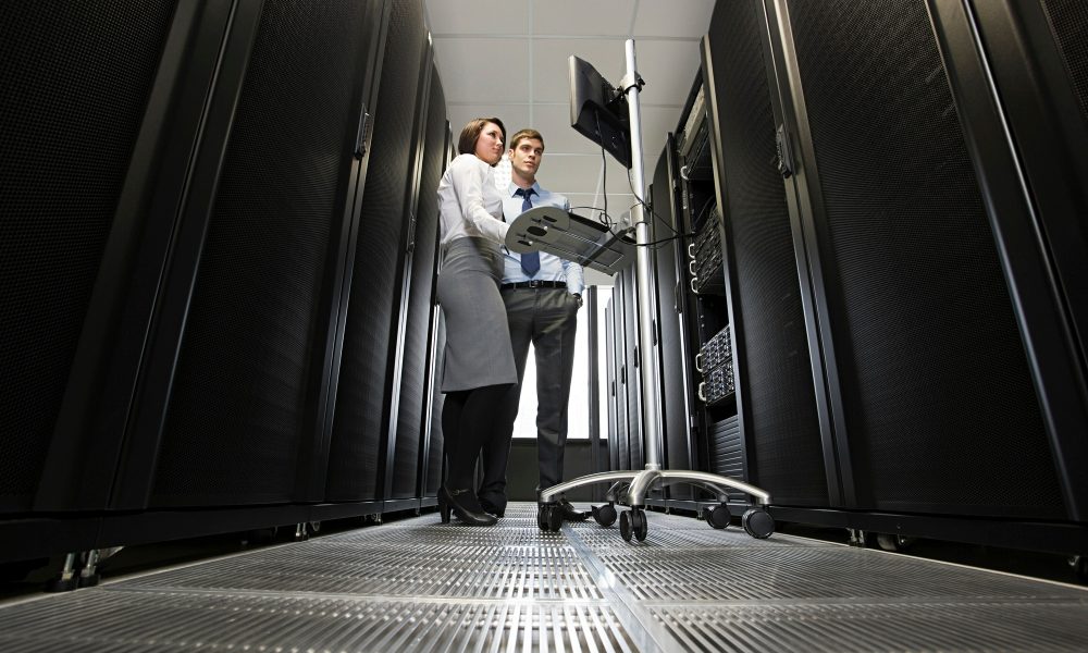 Professionals troubleshooting in a data center server room