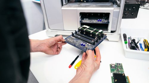 Technician Repairing RAM Module on Computer Motherboard