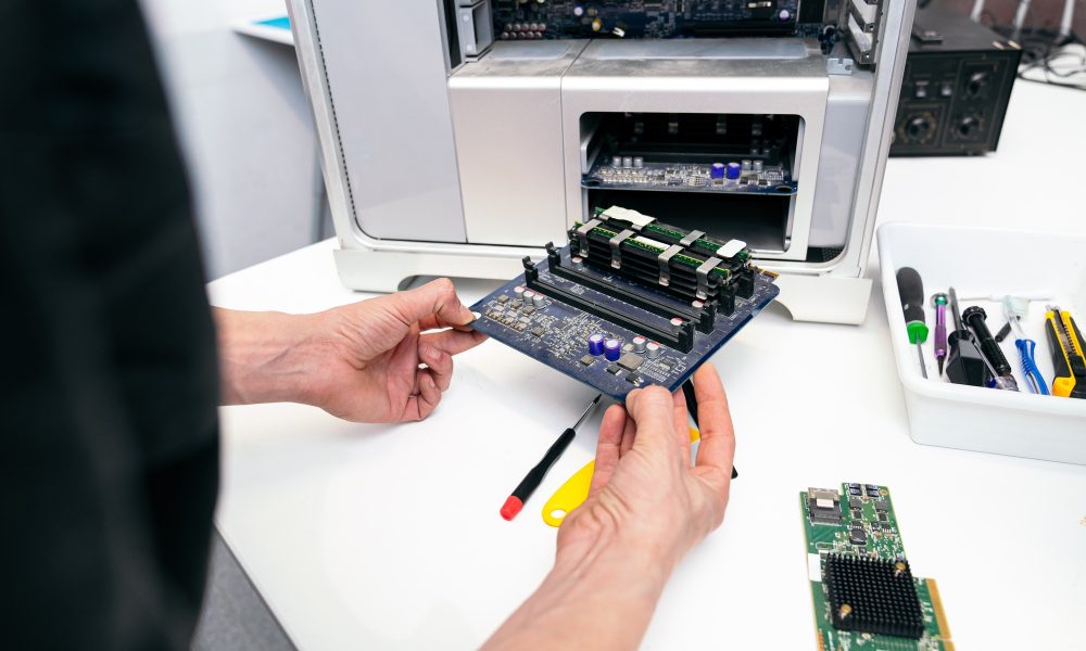 Technician Repairing RAM Module on Computer Motherboard