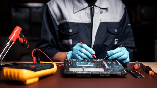 Technician under fixed and repairing computer mainboard process by used multimeter AC Voltage for an